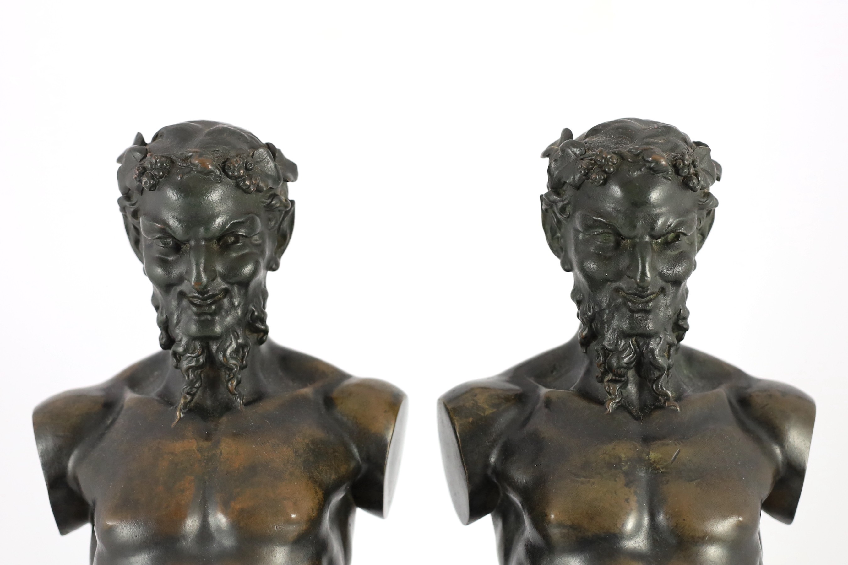 A pair of early 20th century French bronze terms, each in the form of a satyr, 16cm wide 62cm high